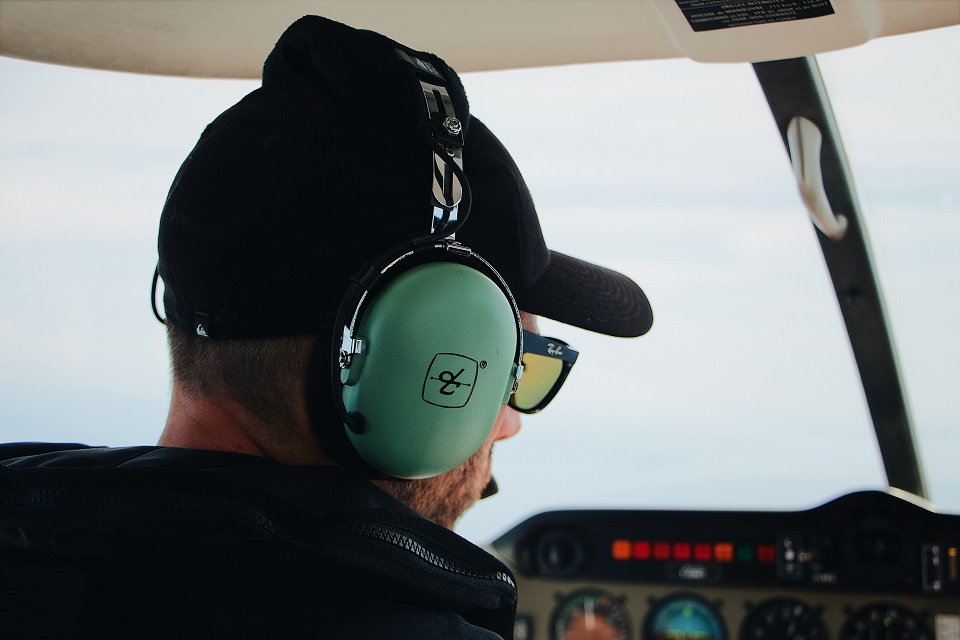 How to land your first pilot job, pilot in cockpit with headset