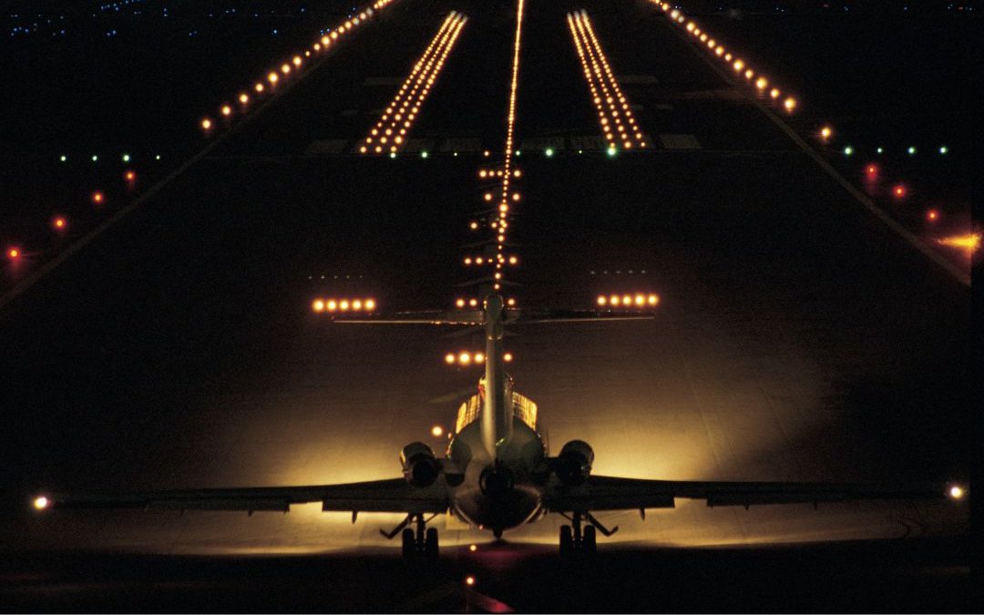 runway at night, airport lights, plane taxiing on the runway